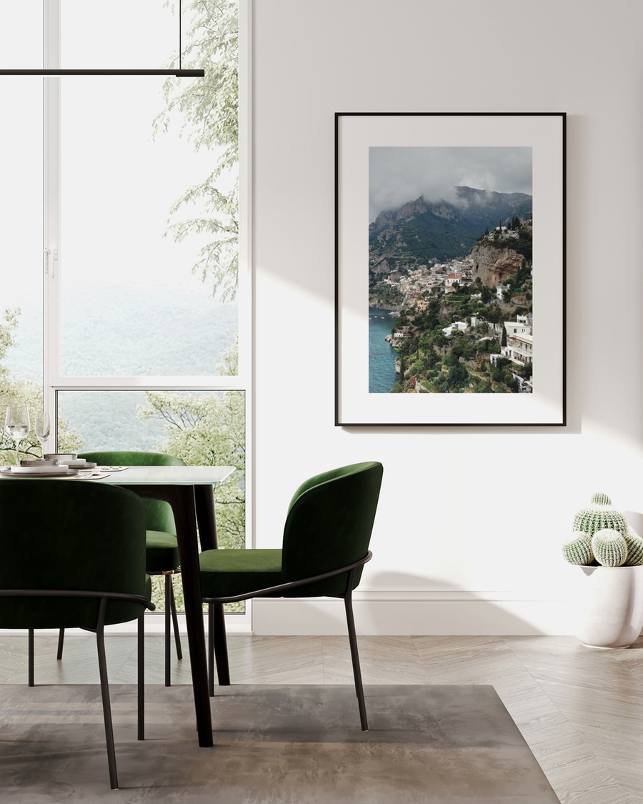 A poster of a Cliffside coastal town overlooking deep blue sea