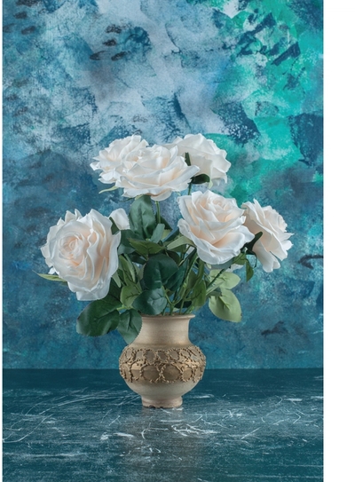 White roses in ceramic vase with teal background