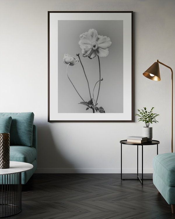 Anemone in Silver poster in a slim dark frame above a teal sofa in a modern living room