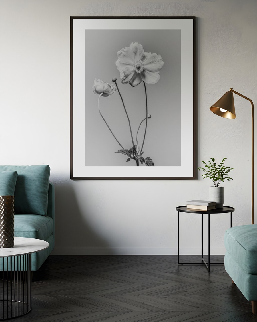 Anemone in Silver poster in a slim dark frame above a teal sofa in a modern living room
