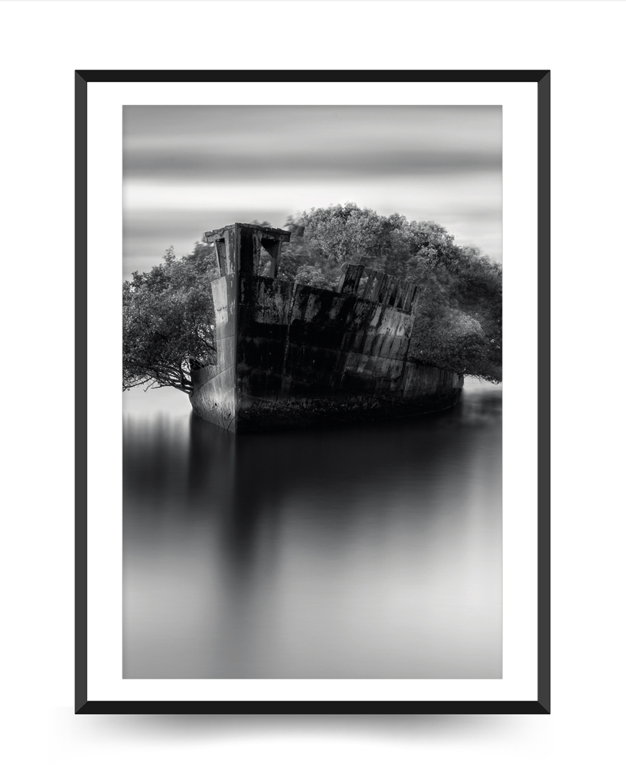 A poster of a Abandoned shipwreck reflected in calm monochrome water