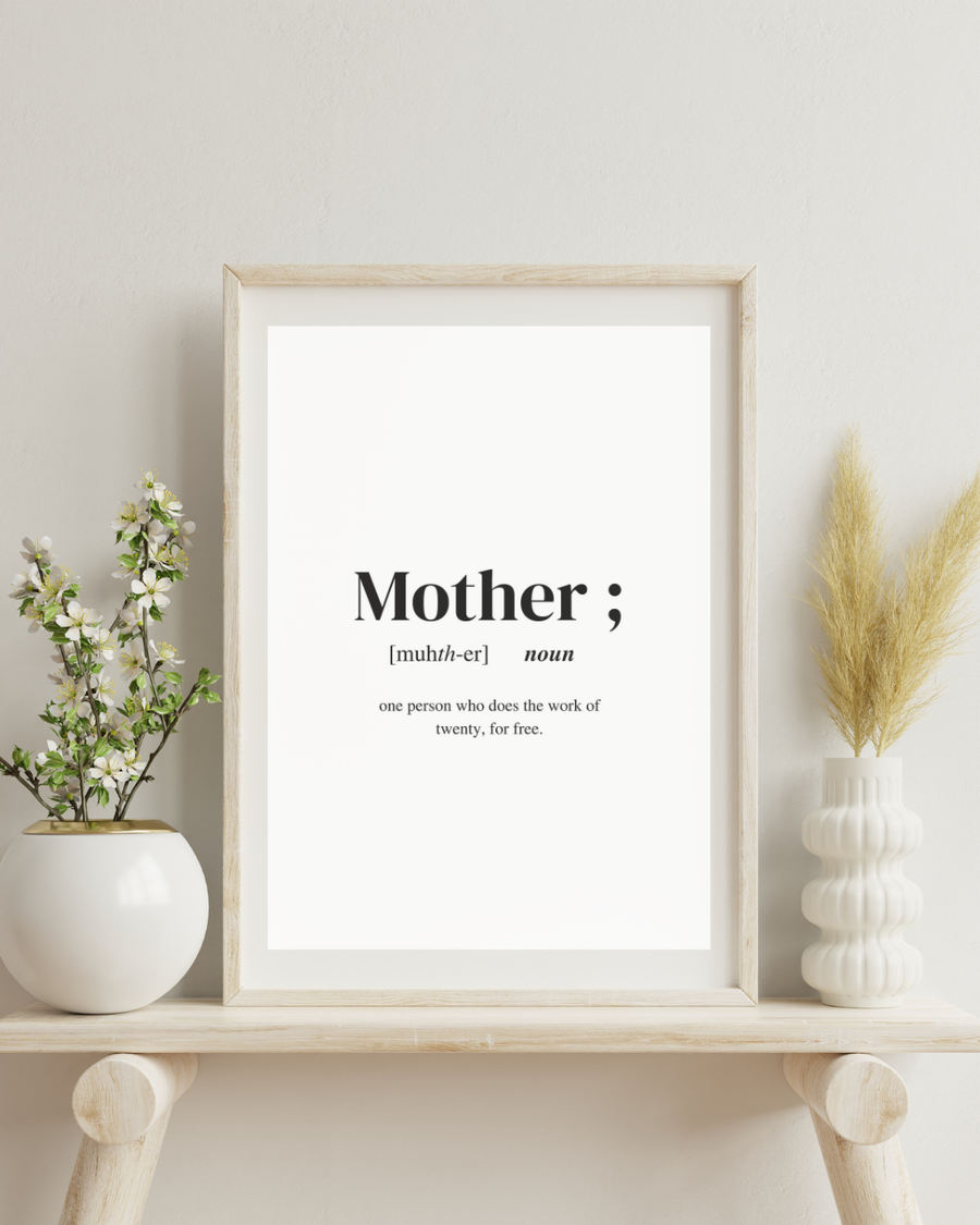 A poster of the definition of the word Mother placed between two vases