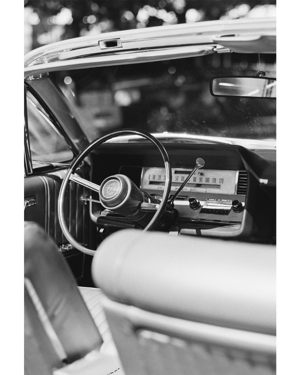 Black and white vintage car interior from driver seat