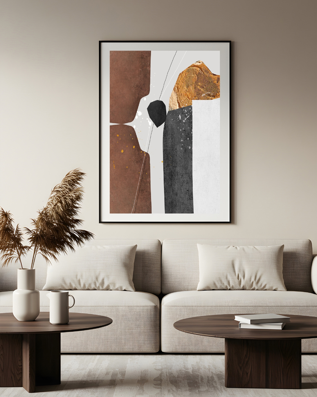 Living room with a brown, black and gold abstract poster in a thin black frame above a beige sofa and dark wood tables