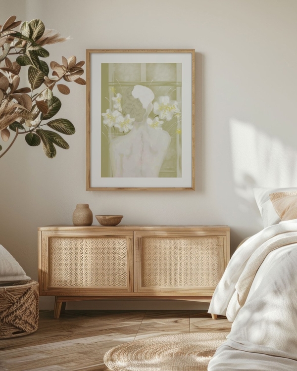 Blooming Shoulders poster in a light oak frame above a rattan sideboard in a boho bedroom