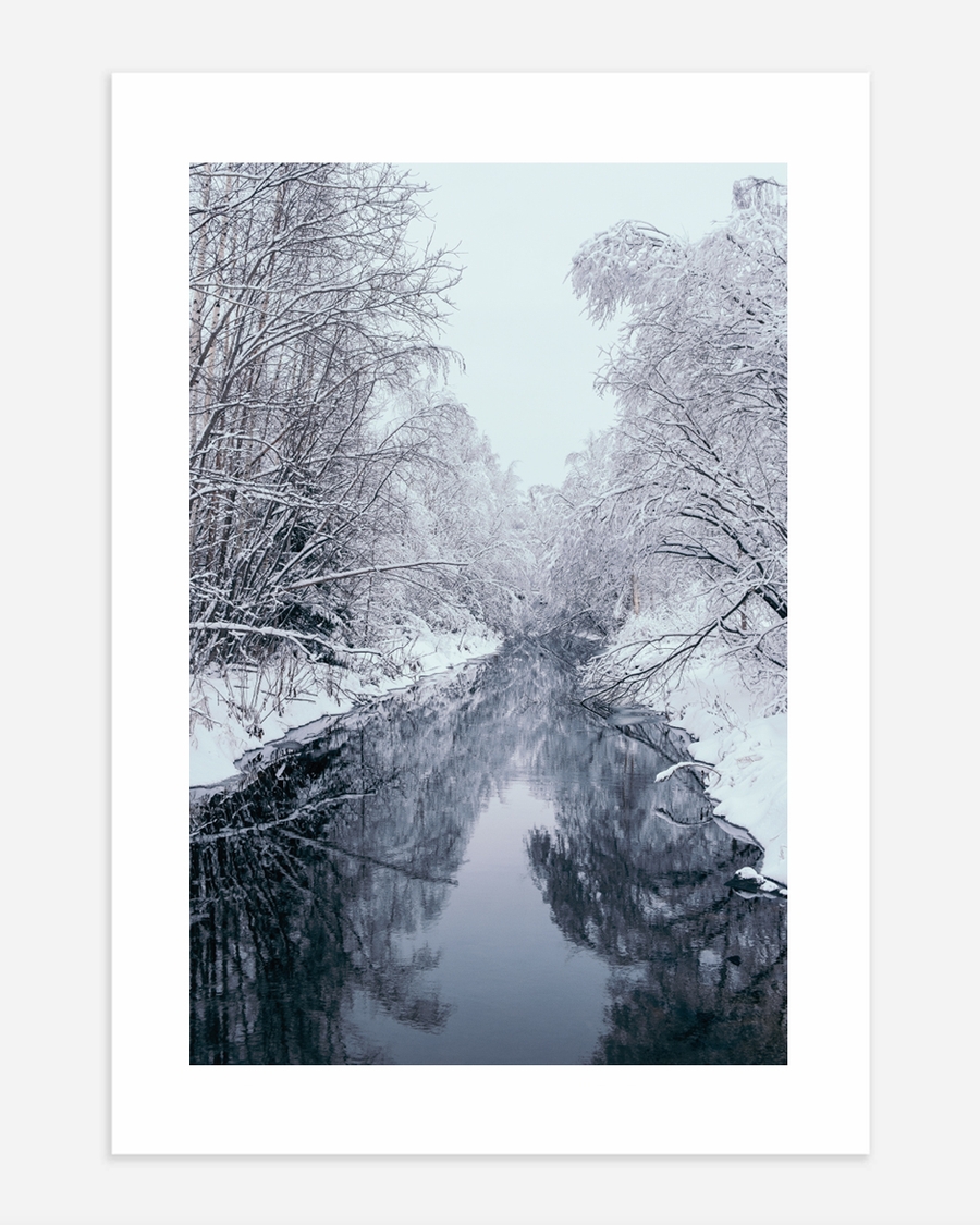 A poster of a Snow covered trees reflected along quiet winter stream