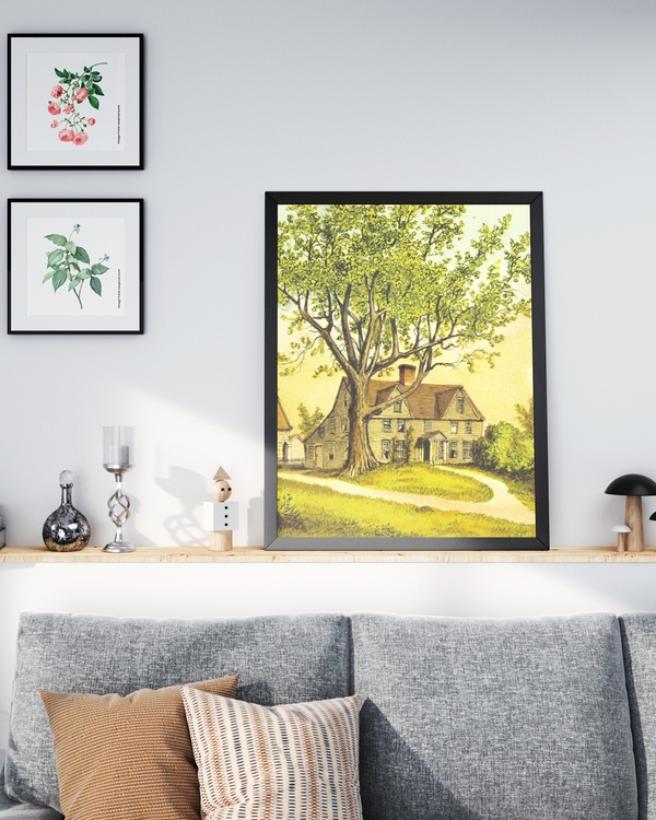 Poster of a painting of a house with a tree in front of it placed on a shelf.