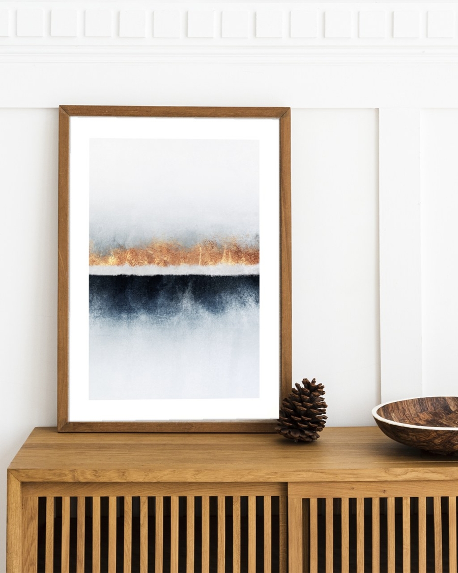 Copper Seam poster in a wooden frame leaning on an oak sideboard against white panelled wall