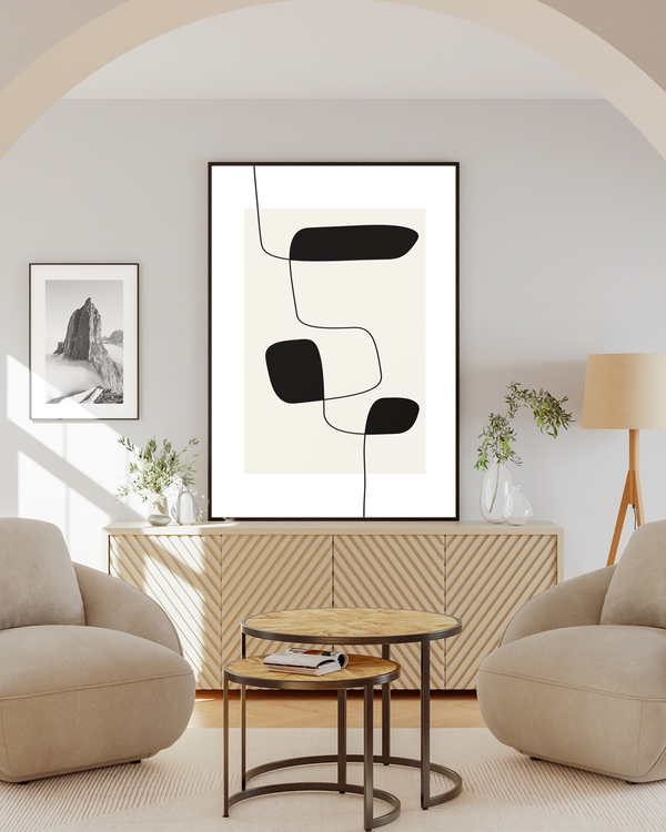A poster of black random lines with abstract shapes hanged on a wall next to a poster of a mountain