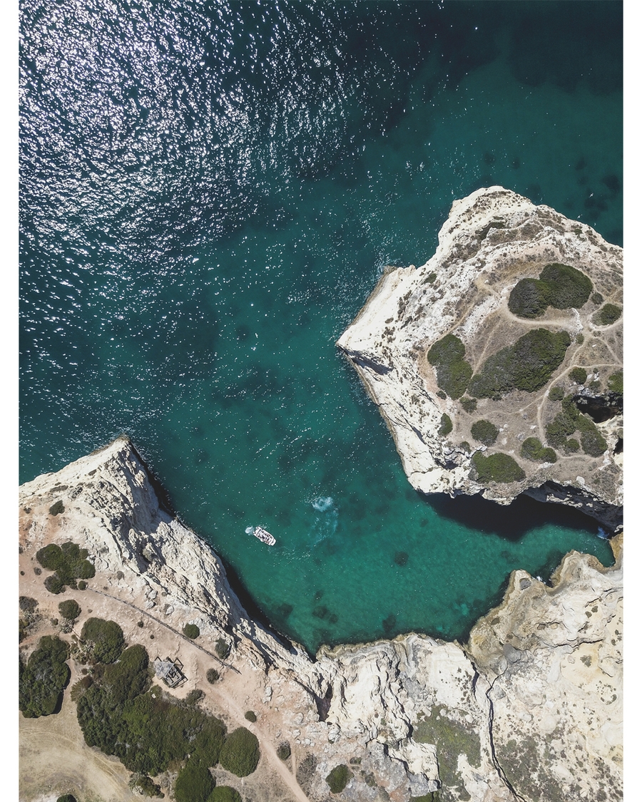Aerial view of turquoise sea and rocky cliffs