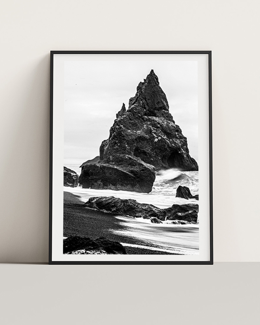 A poster of a Black and white photo of rugged sea rock