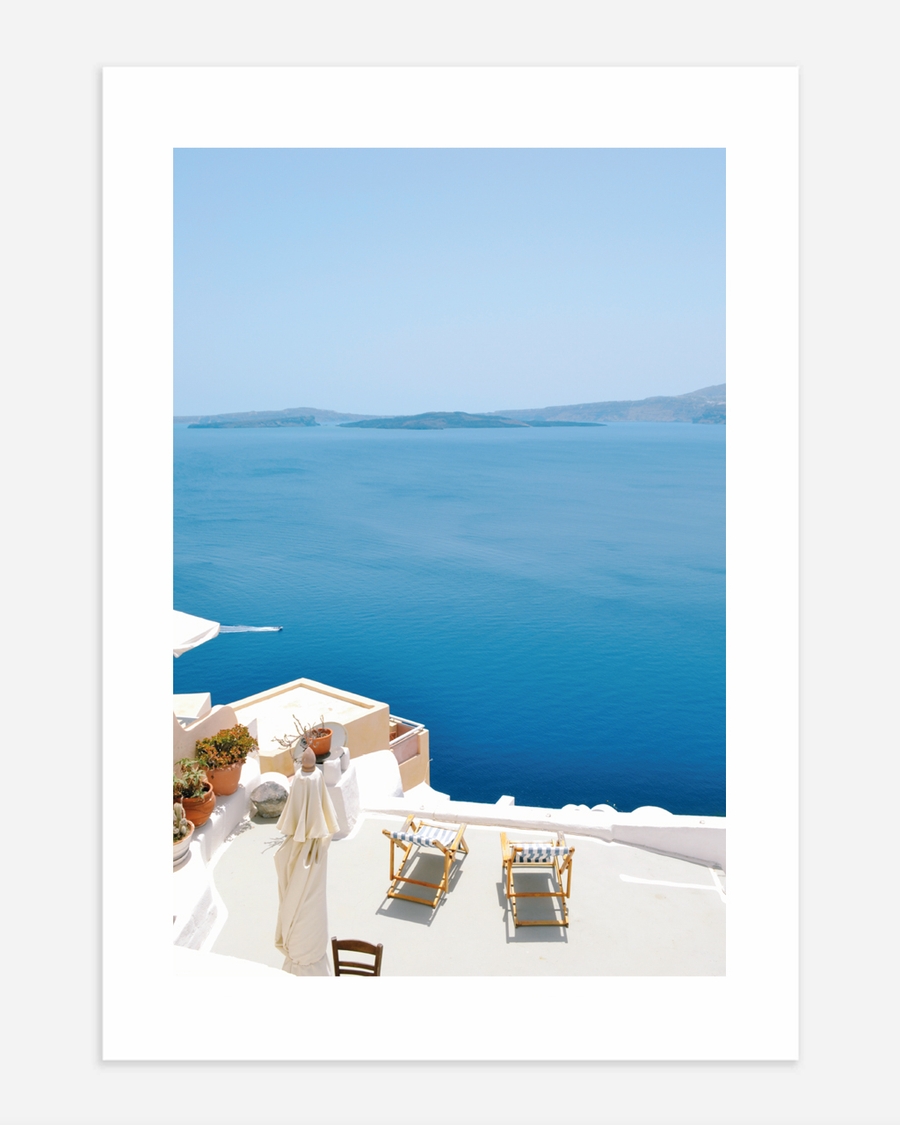 A poster of a White terrace overlooking deep blue sea
