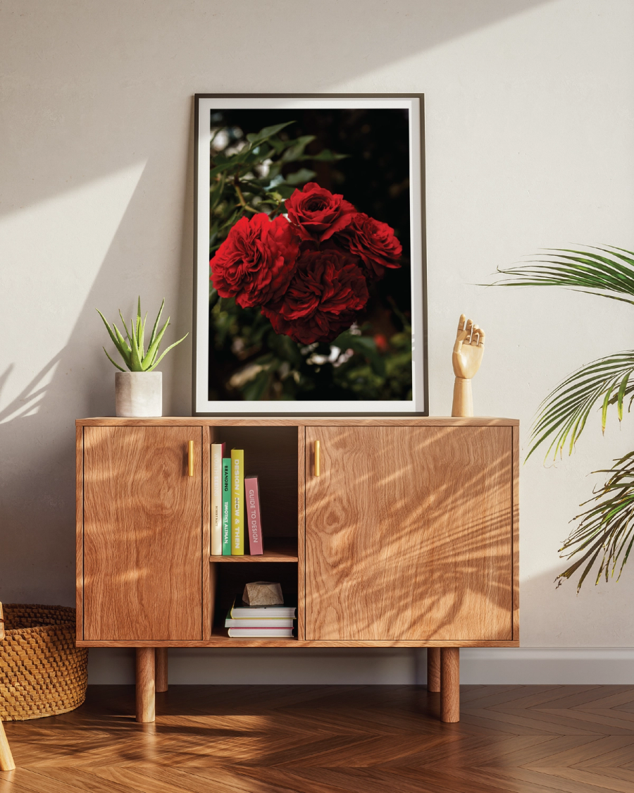 A Bouquet of Red Flowers poster on a brown table