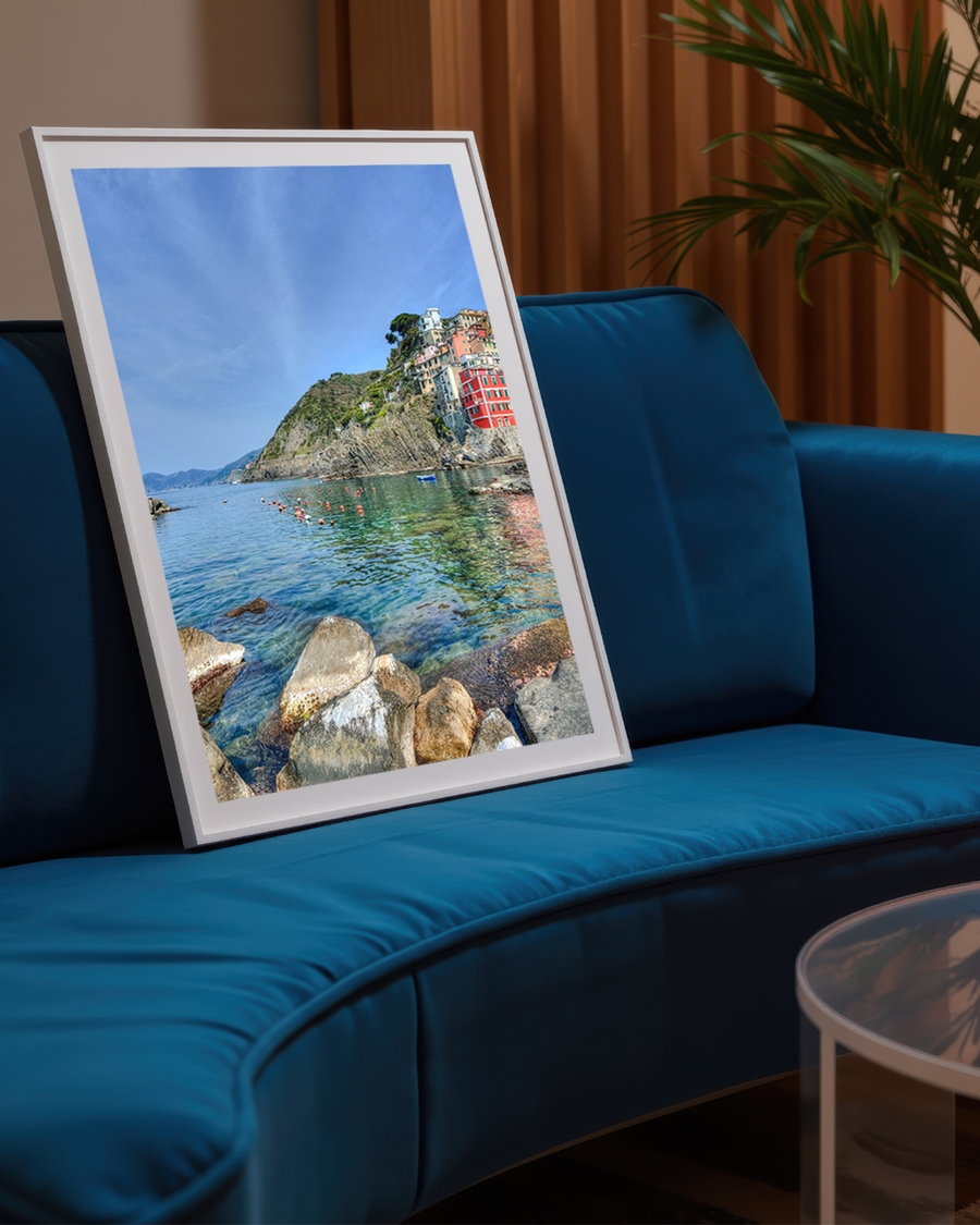 A poster of a Colorful houses on rocky coast with clear water