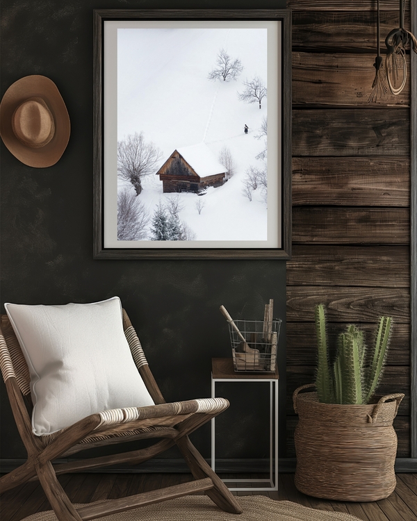 A poster fo a wooden cabin in snowy landscape with bare trees