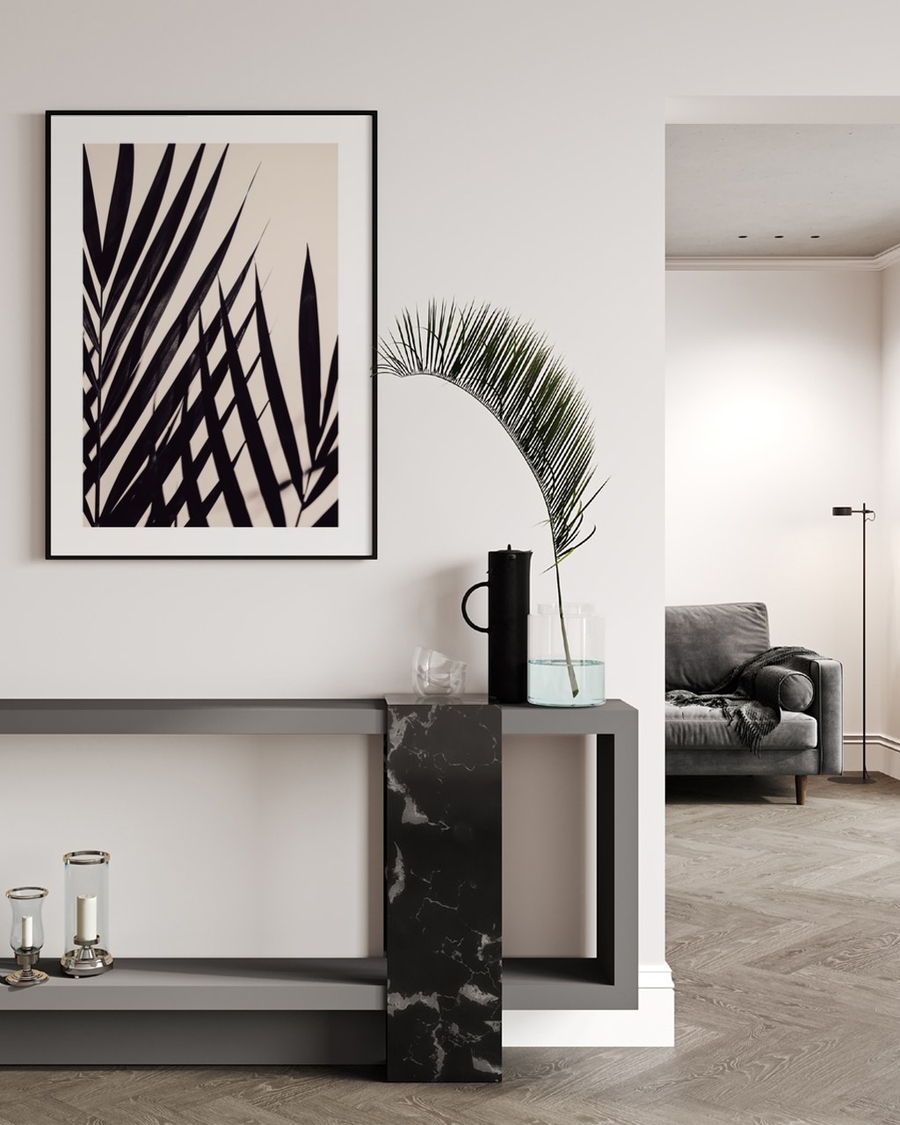 Palm Silhouette poster in a slim black frame above a dark console table in a bright modern hallway