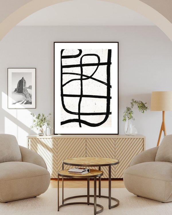 Ink Crossings poster in a slim black frame above a fluted sideboard in a bright living room