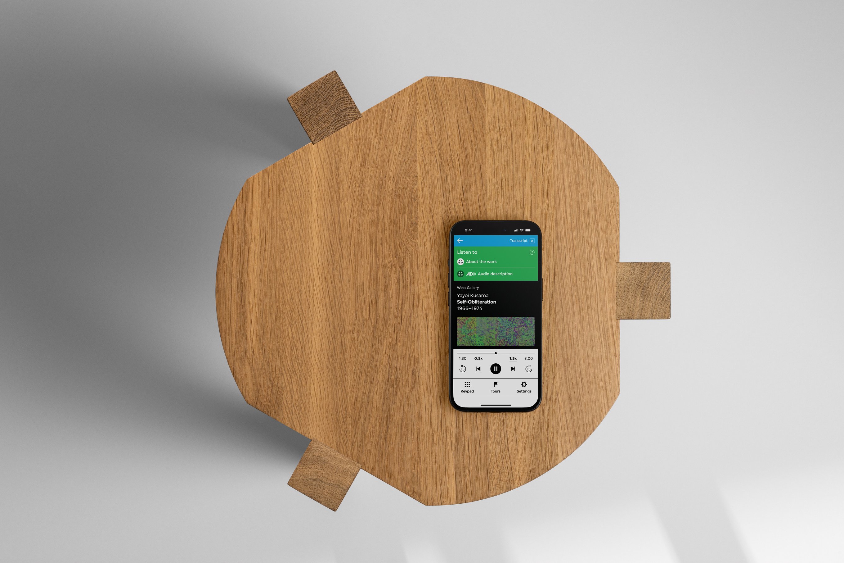 A bird's eye view of an iPhone on a wooden stool.