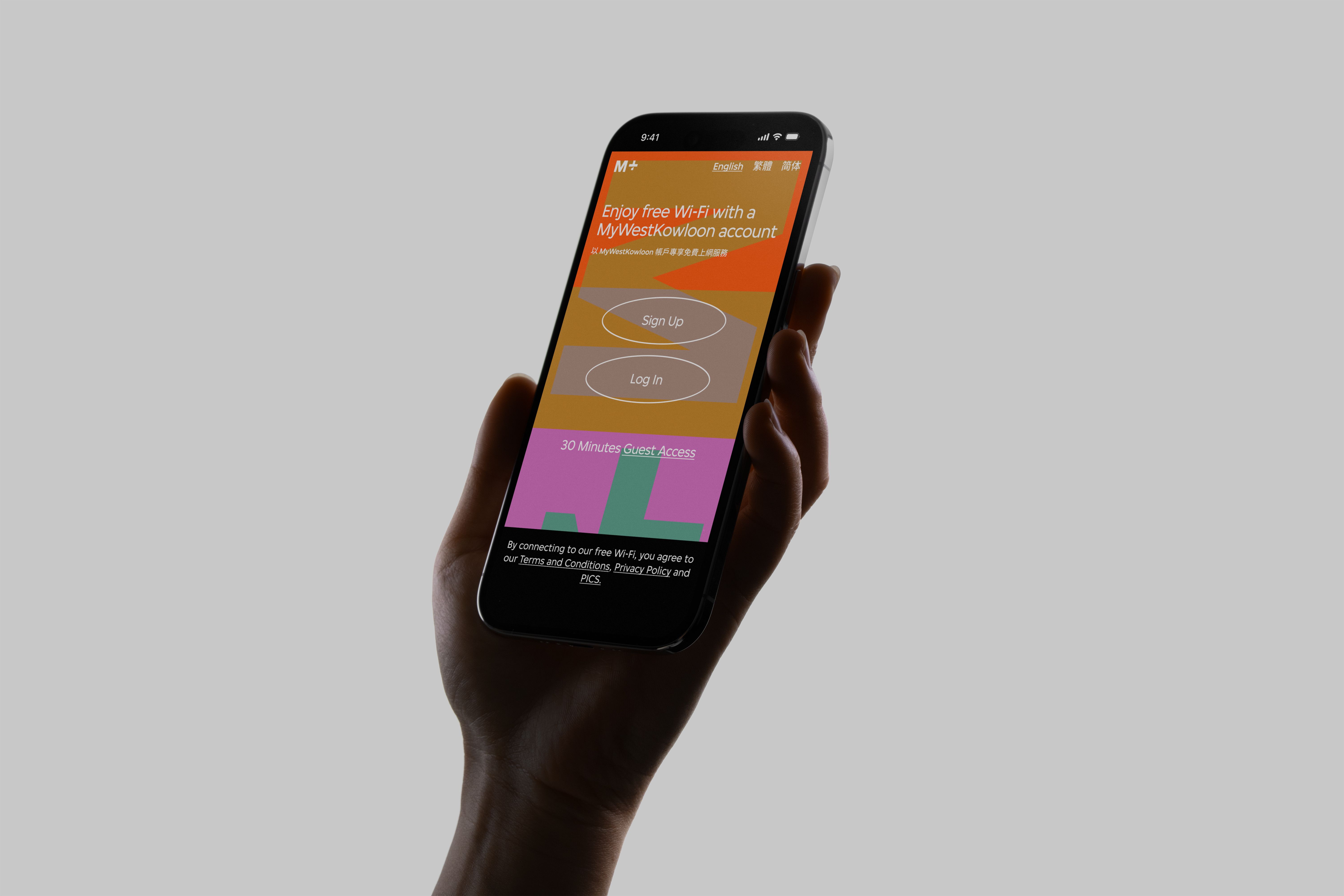 A person's hand holding an iPhone displaying the M+ Wi-Fi homepage on its display.
