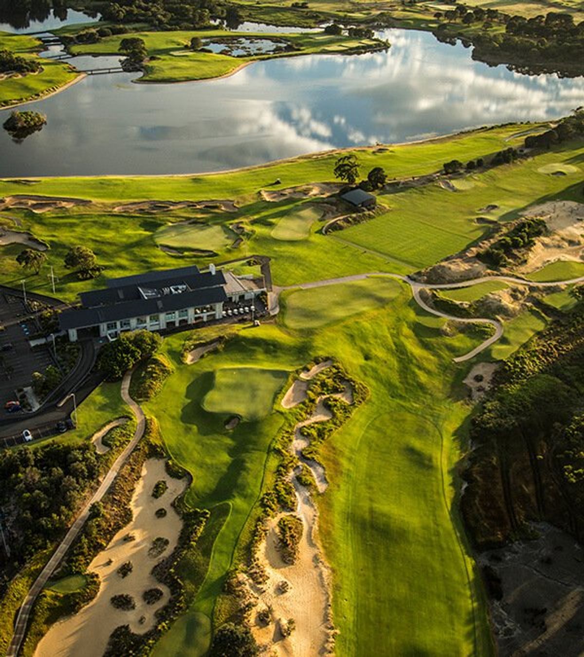Aerial view of the clubhouse, a green and a lake at The Lakes Golf Club, Sydney