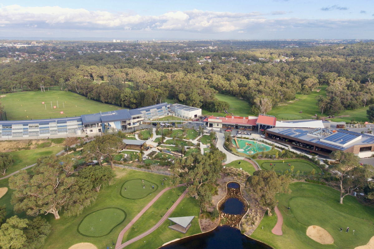 Aerial view of Wembley Golf Course complex showing the driving range, mini-golf course, putting greens, and clubhouse buildings.