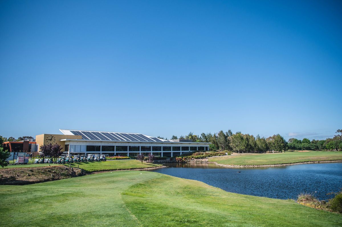 The clubhouse and golf carts beside a lake at Gungahlin Lakes Golf & Community Club