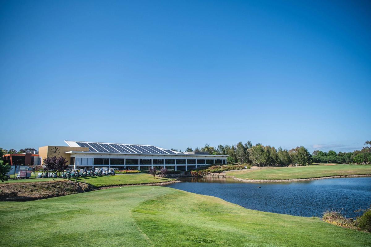 The clubhouse and golf carts beside a lake at Gungahlin Lakes Golf & Community Club