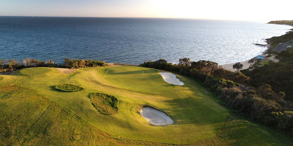 Aerial view of a clifftop green overlooking the coastline at Mornington Golf Club