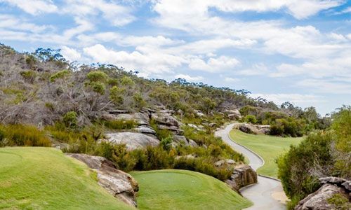 A fairway winding through sandstone outcrops and bushland at Elanora Country Club, Sydney