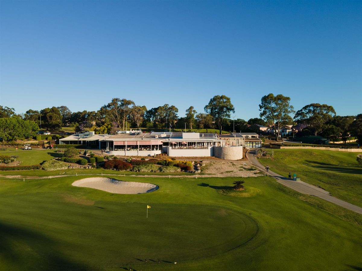 Aerial view of the clubhouse and a bunkered green at Campbelltown Golf Club, with the fairway in the foreground.