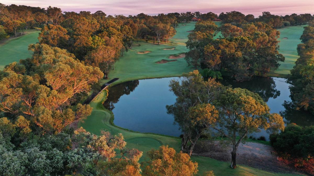 Aerial view of a fairway, lake and green at Lake Karrinyup Country Club, Perth, at sunset