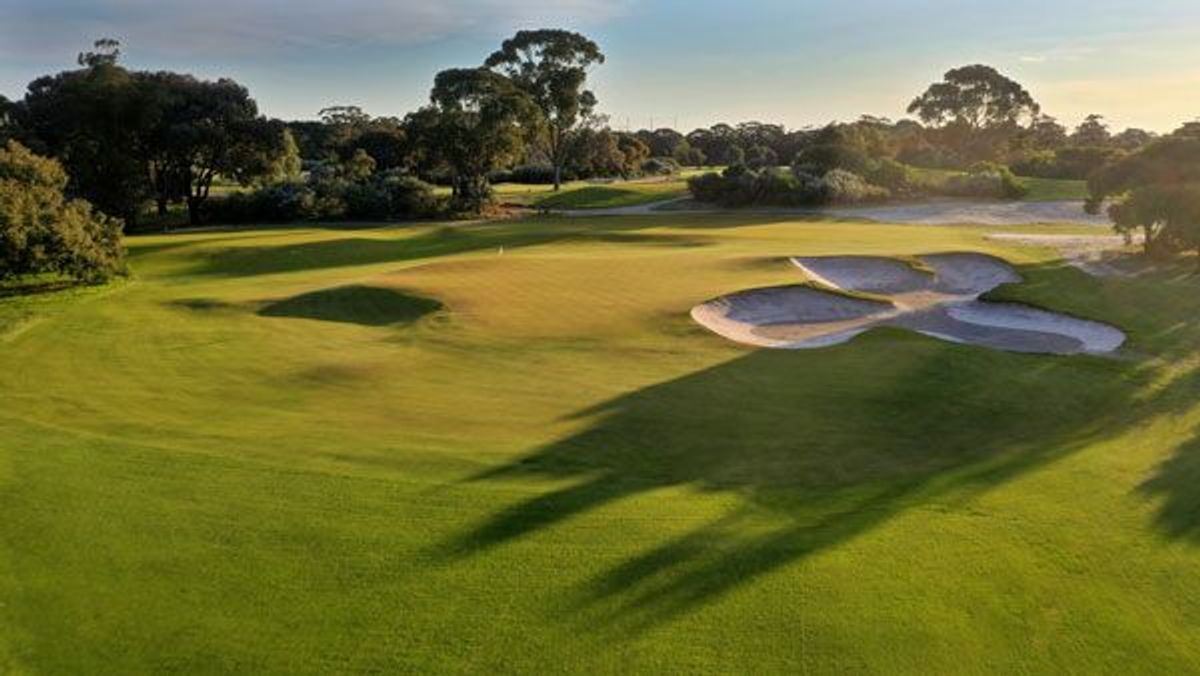 Green surrounded by bunkers and trees at Sandringham Golf Links (Sandy Golf Links)