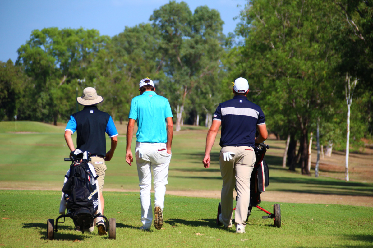 Golfers walking the fairway with trolleys at Palmerston Golf & Country Club