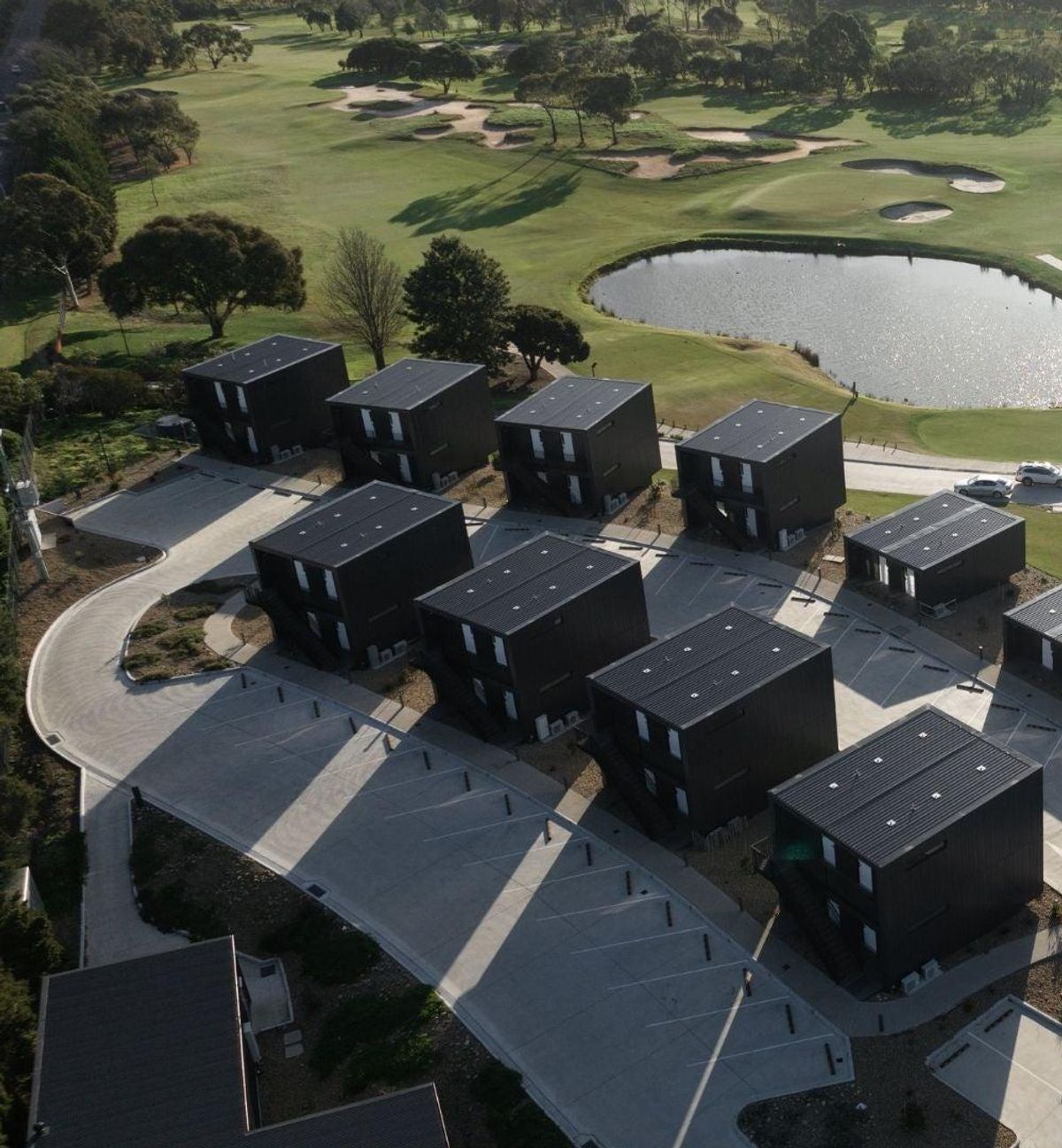 Aerial view of Curlewis Golf Club's fairway, bunkers and pond alongside the on-site accommodation villas.