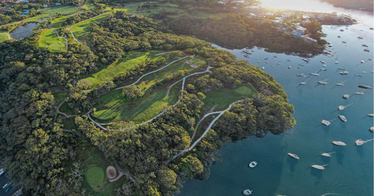 Aerial view of Northbridge Golf Club's tree-lined course on the harbour peninsula