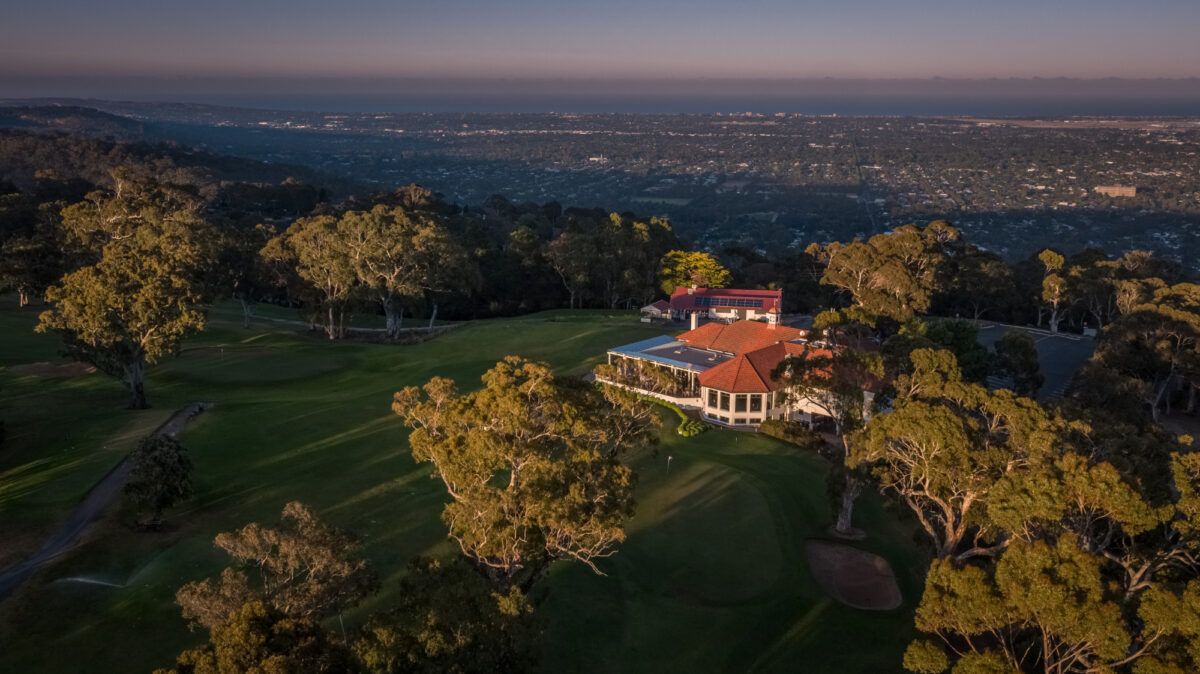 Aerial view of Mount Osmond Golf Club's clubhouse and fairways overlooking Adelaide at dusk