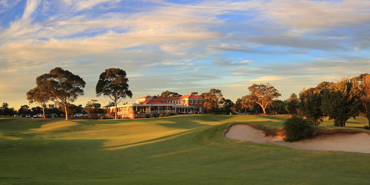 The clubhouse at Bonnie Doon Golf Club, Sydney, seen across a green at sunset
