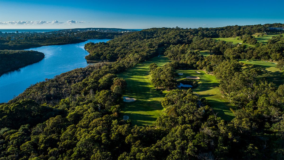 Aerial view of a fairway through bushland beside a waterway at Wakehurst Golf Club, Sydney