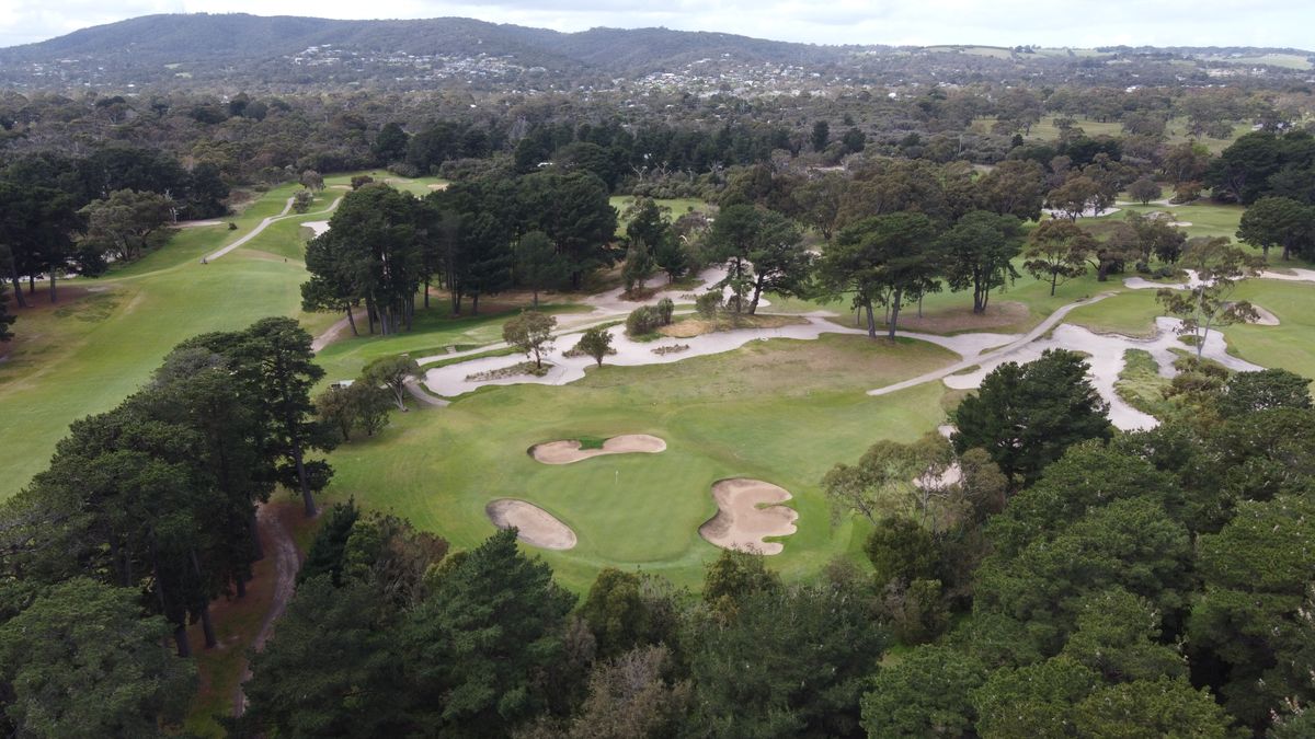 Aerial view of a green with bunkers surrounded by trees at Rosebud Country Club