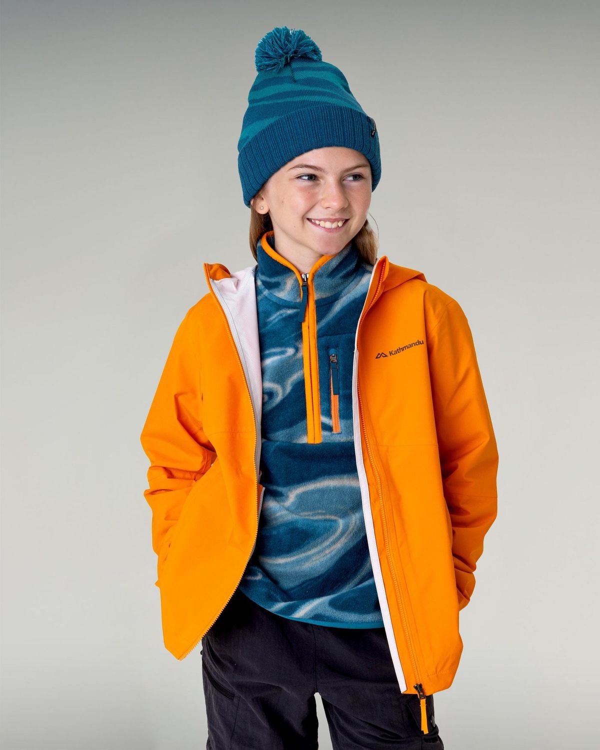 Kathmandu Kids' Trailhead Stretch 2.5L Rain Jacket - Magma