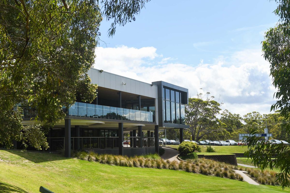The modern clubhouse building at Nelson Bay Golf Club surrounded by trees