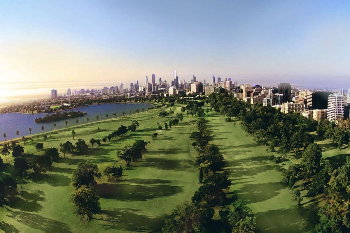 Aerial view of Albert Park Golf Course fairways lined with trees, with Albert Park Lake and the Melbourne city skyline behind.
