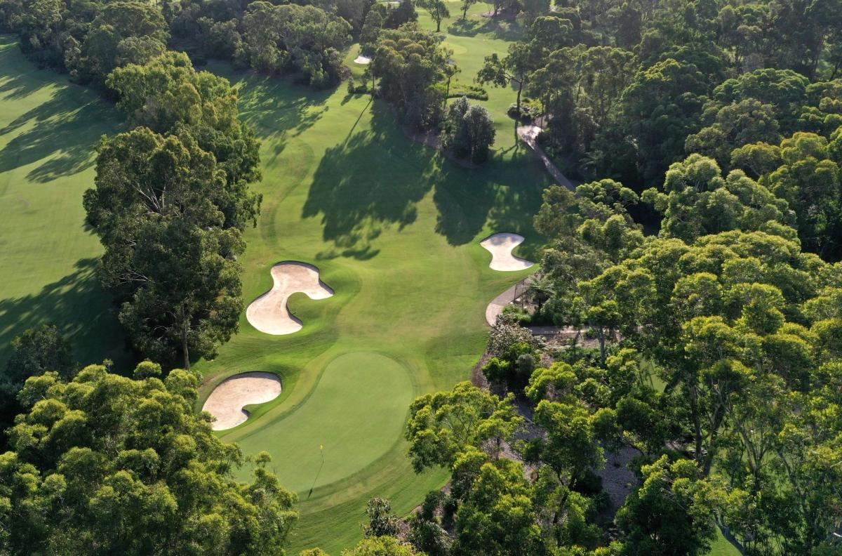 Aerial view of a bunkered green surrounded by trees at Avondale Golf Club, Sydney