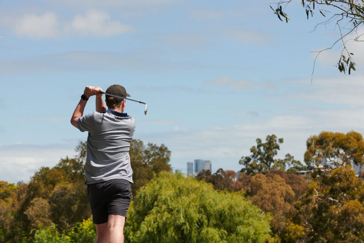 A golfer walking the fairway at Northcote Public Golf Course
