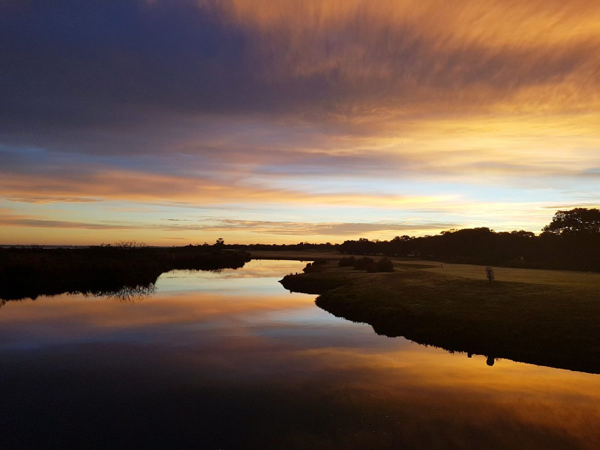 Sunset reflected on the water hazard bordering Queenscliff Golf Club's fairway