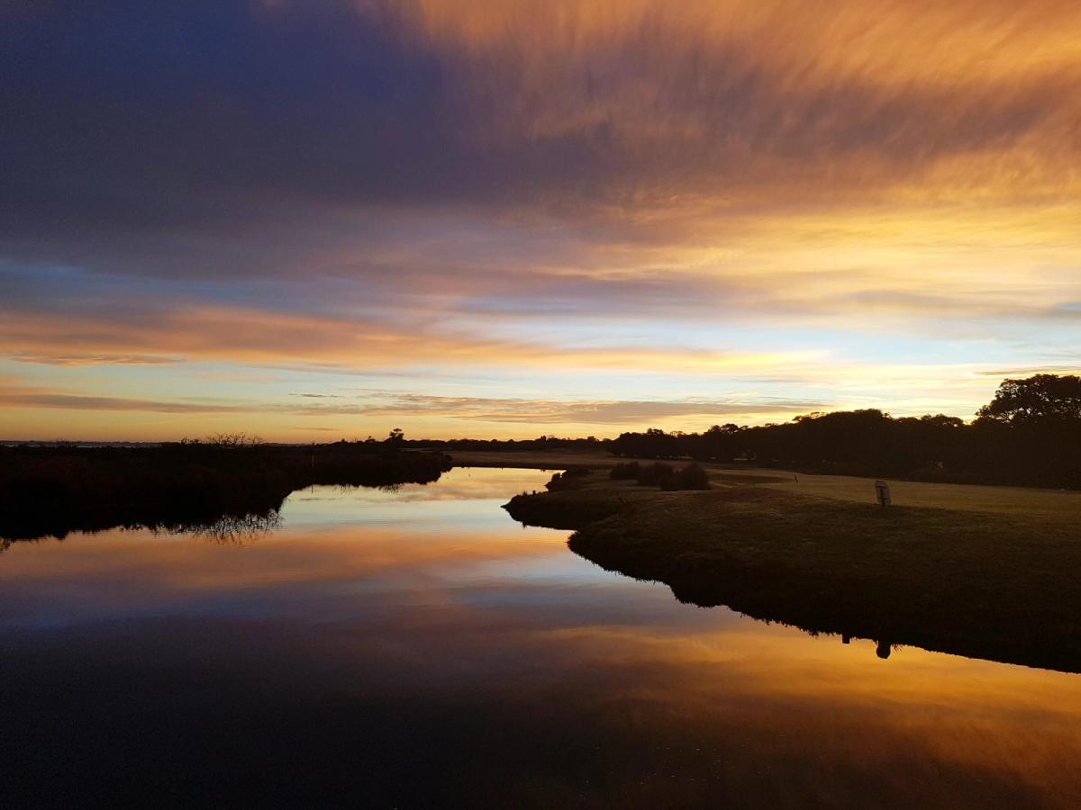 Sunset reflected on the water hazard bordering Queenscliff Golf Club's fairway