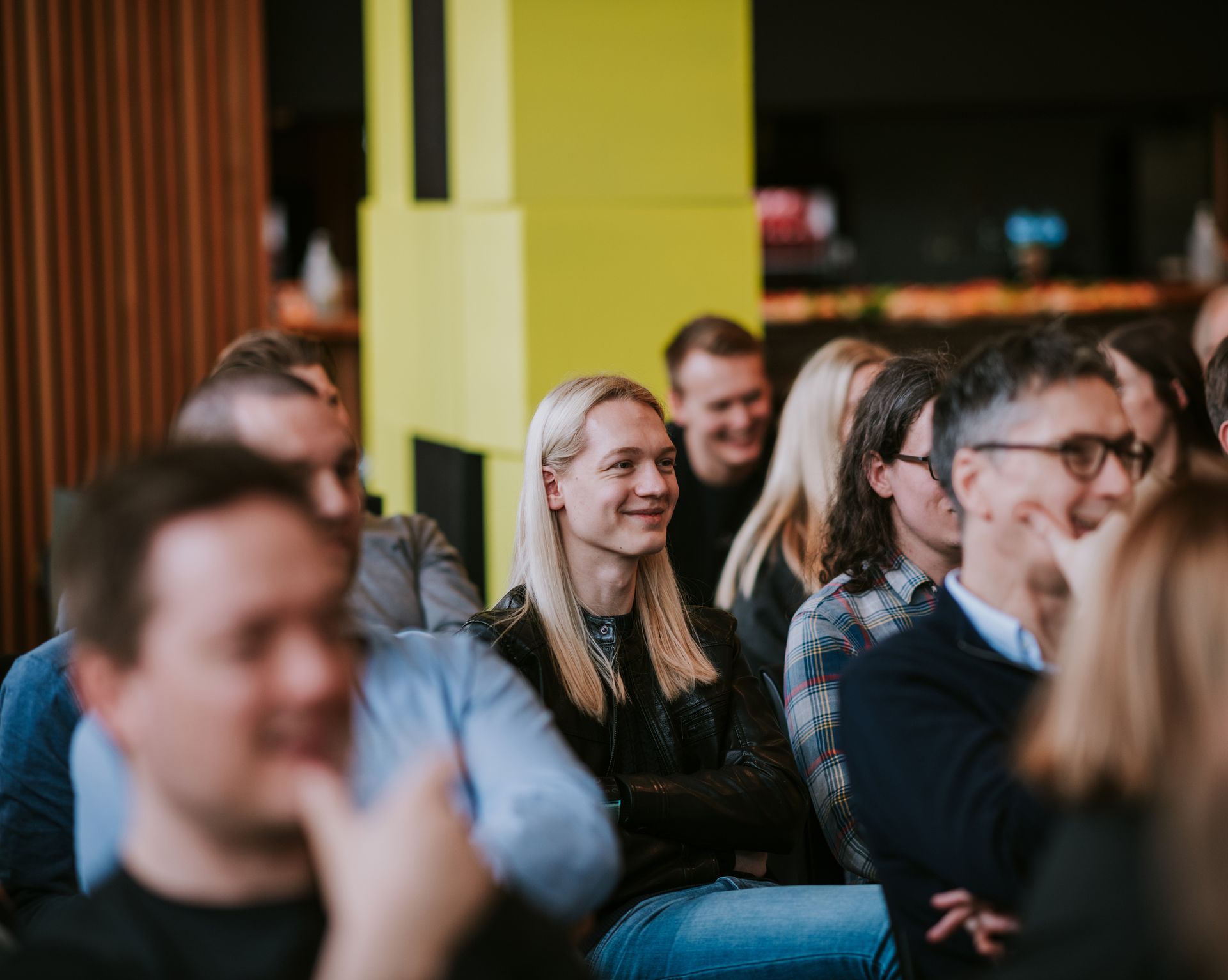 A crowd of Solwr employees looking at a stage during a corporate event