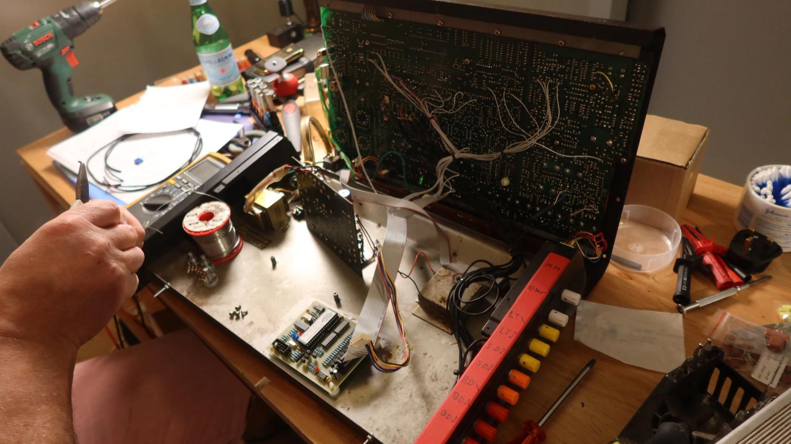 The TR-808 open on the bench during the modification