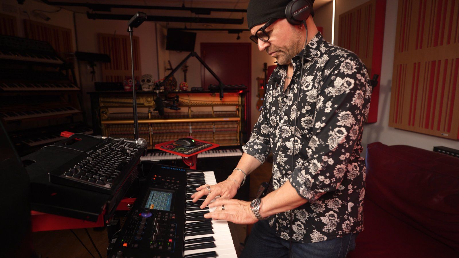 Claudio at the keyboard with headphones on, working out the arrangement