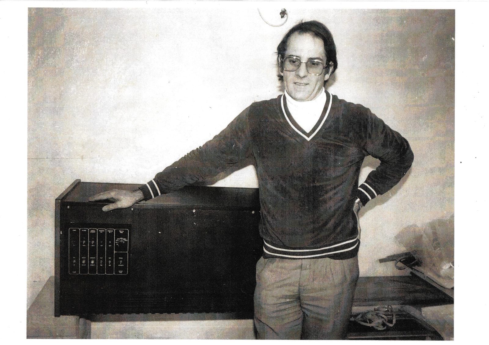 Tony Furse standing beside an early rack-mounted computer